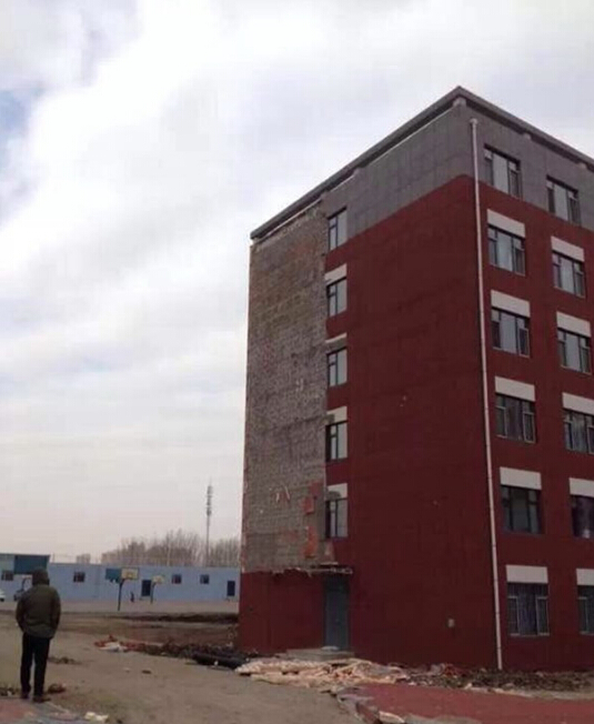 Outer wall of college dorm crumbles under average winds