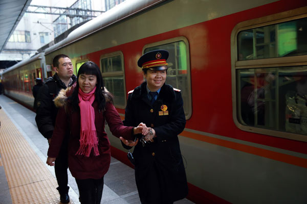 Railway station workers enjoy happy crowds of travelers