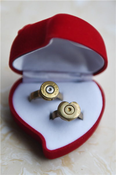 Couples exchange 'bullet shell rings' at group wedding in military camp