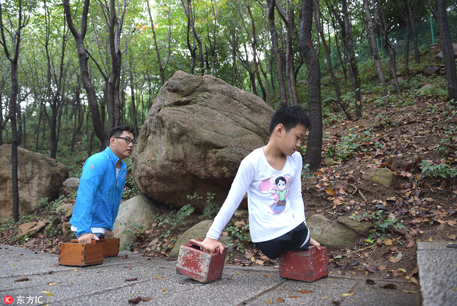 Legless man and boy climb a mountain together