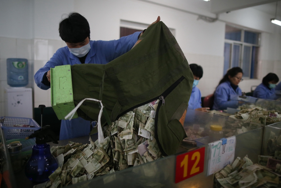 Cramped fingers, 24-hour security and sticky tape all part of a money counter's job