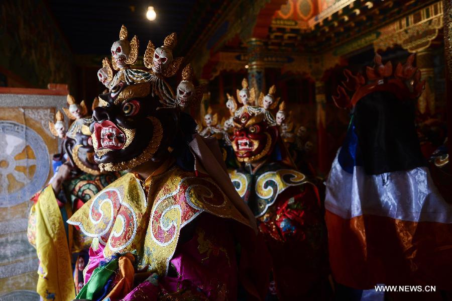 Monks wearing masks rehearse Gesar opera at Chalang Temple in NW China