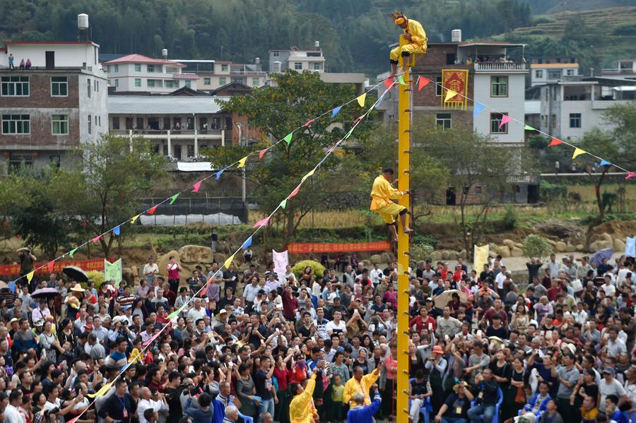 Stunt 'climbing on blades' performs in China's Fujian province