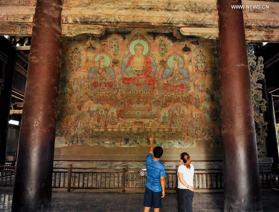 Experts restore ancient murals at temple in N China