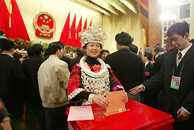 A deputy from Guizhou Province casts her ballot during the first plenary meeting of the 10th National People's Congress in March, 2004. The NPC has contributed significantly to the establishment of a legal system. [newsphoto/file]