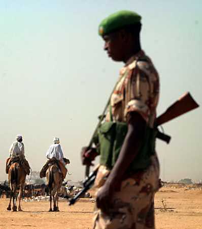 A Rwandan African Union soldier patrols at Abushouk camp near El Fasher in North Darfur, Nov. 3. Sudan's Darfur region could fall into anarchy unless the 15-nation Security Council takes bold action and thousands of African Union troops arrive quickly, a senior U.N. official warned on November 4, 2004. [Reuters]