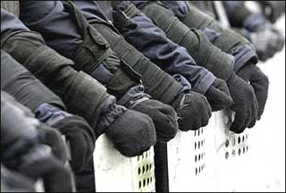 Members of the special police forces hold their shields outside the Presidential office building in Kiev November 27, 2004.