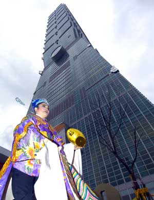 Taipei 101, the world's tallest building, opens on December 31, 2004 after six years of construction. The 508-meter skyscraper has "passed the test" of several powerful earthquakes, including the worst tremor, measuring 7.6 on the Richter scale in September 1999 and a strong quake measuring 6.8 on the Richter scale on March 31 2002. The light green building, the brainchild of Taiwan's noted architect C.Y. Lee, looks like petals of a flower unfolding or sections of a bamboo rising from the ground. Its structure is based on steel with reinforced concrete. The exterior wall is a glass curtain with double glazed heat reduction clear glass. Construction cost 58 billion Taiwan dollars (US$1.8 billion) and was financed by the Taipei Financial Center Corp. The observatory on the 89th floor will open for trial operation on January 19 and is expected to officially open in March. [newsphoto]