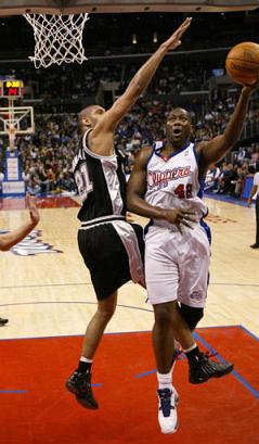 San Antonio Spurs (news)' Tim Duncan (news), left, defends as Los Angeles Clippers (news)' Elton Brand (news) drive to the basket during the first half in Los Angeles on Friday, Dec. 31, 2004. (AP Photo/Chris Carlson) 