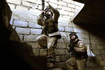 U.S. Army 1st Battalion, 24th Infantry soldiers search a building on patrol in Mosul, Iraq Monday, Jan. 24, 2005. U.S. and Iraqi officials fear a spike in bloodshed and have announced massive security measures to protect voters from possible insurgent attacks during the elections. [AP]