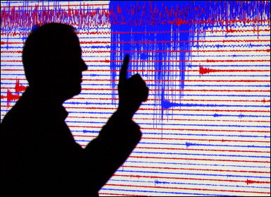 A geophysics professional points on a seismogram of an earthquake. A strong earthquake measuring 6.9 on the Richter scale hit the southern Philippines but there were no immediate reports of damage or casualties, the government said.(AFP/File /Michael Urban) 