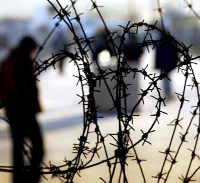 A Palestinian man waits to cross Erez border crossing between Gaza Strip and Israel February 23, 2005. The Palestinian prime minister failed to win approval for his new cabinet for the third successive day on Wednesday in a deepening crisis with lawmakers demanding more reformers and fewer Yasser Arafat loyalists. [Reuters]