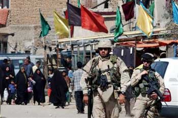 U.S. Army soldiers patrol in the Sadr City section of Baghdad, Iraq, Friday, March 18, 2005. This weekend marks the second anniversary of the U.S. -led invasion of Iraq. [AP]