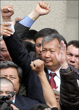 Kyrgyz opposition leader Kurmanbek Bakiyev in front of the Parliament building in Bishkek. Kyrgyzstan's new leaders tightened their grip on power, naming an interim head of state and calling a fresh election, as the nation's ousted ruler denounced what he called a coup d'etat and vowed to return.(AFP/Alexander Nemenov)