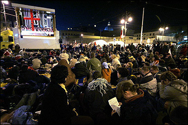 Faithfuls watch a giant screen in Risorgimento Square in Rome, near the Vatican, on the eve of Pope John Paul II's funeral.(AFP/Mario Laporta) 