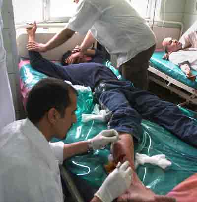 An Iraqi man is treated at the Yarmouk Hospital following a roadside bomb attack in Baghdad April 15, 2005. A large explosion ripped through the upscale Mansour district as a U.S. military convoy was driving past, killing one person and injuring at least five, witnesses said. There were no immediate reports on U.S. casualties. [Reuters]