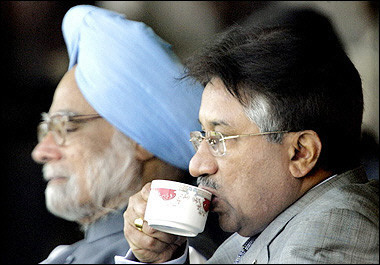 Pakistani President Pervez Musharraf (R) sips a cup of tea next to Indian Prime Minister Manmohan Singh while watching the final one day international cricket match between India and Pakistan at Feroz Shah Kotla stadium in New Delhi.(AFP