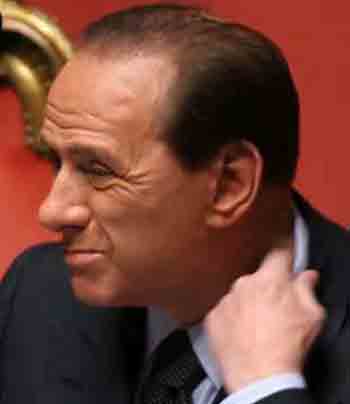 Italy's Prime Minister Silvio Berlusconi pulls at his collar during a Senate session in Rome April 20, 2005. President Carlo Azeglio Ciampi began talks with Italy's political leaders to try to assemble a new government that Berlusconi, who resigned as prime minister, is again expected to lead. Photo by Alessia Pierdomenico/Reuters