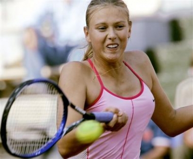 Russia's Maria Sharapova returns the ball to fellow Russian Elena Bovina during their quarter final match of the women's Italian Open tennis tournament at Rome's Foro Italico, Friday, May 13, 2005. Sharapova beat Bovina 6-2, 6-2. (AP