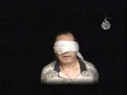 A video grab Egypt's envoy to Iraq Ihab el-Sherif at is shown speaking while blindfolded at an unknown location in Iraq in a video released July 7. (Reuters) 