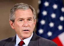 U.S. President George W. Bush answers a question as he and Australian Prime Minister John Howard speak with reporters in the East Room of the White House July 19, 2005. 