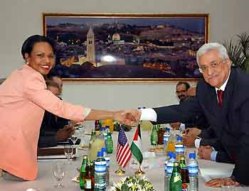 U.S. Secretary of State Condoleezza Rice (L) shakes hand with Palestinian President Mahmoud Abbas in the West Bank city of Ramallah July 23, 2005. U.S. Secretary of State Condoleezza Rice met Palestinian leaders on Saturday to try to preserve a truce shaken by violence and ensure militant attacks do not blight Israel's withdrawal from Gaza. [Reuters]