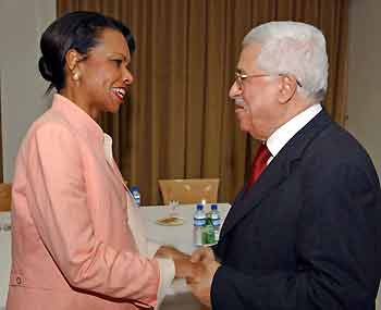 U.S. Secretary of State Condoleezza Rice (L) greets Palestinian President Mahmoud Abbas in the West Bank city of Ramallah July 23, 2005.