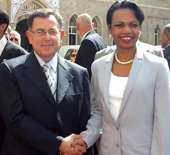 Lebanese Prime Minister Fouad Siniora shakes hands with U.S. Secretary of State Condoleezza Rice at Grand Saray in Beirut July 22,2005. Rice made a surprise visit to Lebanon on Friday to show U.S. support for the new government, the first to be formed since Syrian forces withdrew in April. [Reuters]