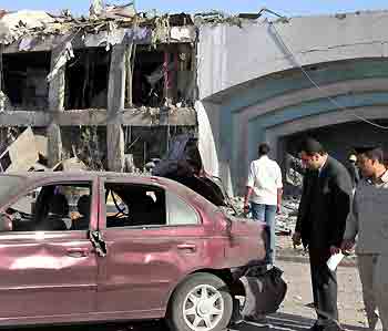 Egyptian security personnel and forensic experts examine the rubble of a hotel after it was destroyed by a bomb in the Red Sea resort of Sharm el-Sheikh July 23, 2005. [Reuters]