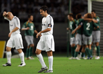 Real Madrid's David Beckham rolls over after being tackled by Tokyo Verdy's Kenichi Takahiro Soma during their friendly match at Ajinomoto Stadium in Tokyo July 25, 2005. Real Madrid suffered an embarrassing 3-0 defeat by Tokyo Verdy on Monday in the first of two pre-season games in Japan.