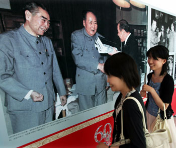 Japanese women visit a Beijing-sponsored photo exhibition in Tokyo July 28, 2005. The exhibition, hosted by the Information Office of the State Council, opened Thursday at the Roppongi Hills commercial complex in Tokyo, featuring relations between China and Japan during the past 60 years since the end of World War II. About 180 pictures collected by leaders, ordinary citizens and media from both countries are on display, attracting more than 3, 000 visitors on the first day of the 11-day exhibition. "There are 2,000 years of friendly exchanges between the two countries. The history of friendly exchanges is the mainstream compared with confrontations," Zhao Qizheng, minister of the Information Office, said at the opening ceremony. [Reuters]