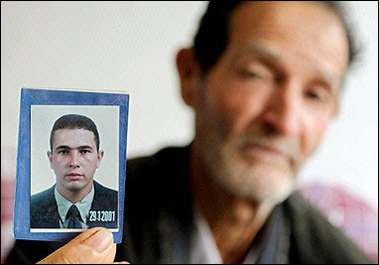 Matozinho Otoni da Silva, the father of the slain 27-year-old Brazilian electrician Jean Charles de Menezes, shows a photograph of his son 24 July 2005.