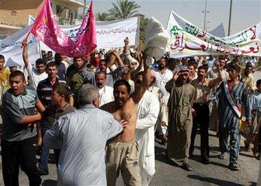 Iraqi Sunnis demonstrate against the country's draft constitution in the city of Ad Dawr near Tikrit, 175 km (110 miles) north of Baghdad, August 23, 2005. 