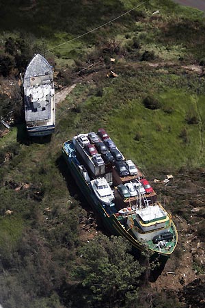  large vessel and a container cargo ship carrying automobiles are pushed inland in Gulf Shores, Alabama, August 30, 2005. Hurricane Katrina strengthened into a rare top-ranked storm and barrelled into the vulnerable U.S. Gulf Coast for a second and more deadly assault on the Gulf Coast.