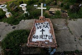 A makeshift tomb at a New Orleans street corner conceals a body that had been lying on the sidewalk for days in the wake of Hurricane Katrina on Sunday, Sept. 4, 2005. 