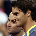 Roger Federer (R) of Switzerland and Andre Agassi of the U.S. stand during the men's final trophy presentation at the U.S. Open tennis tournament in Flushing Meadows, New York, September 11, 2005. 