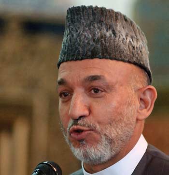 Afghanistan's President Hamid Karzai delivers a speech during a meeting with civil society representatives as part of the campaign for the forthcoming parliamentary elections, in the western Afghan city of Herat September 13, 2005. [Reuters]