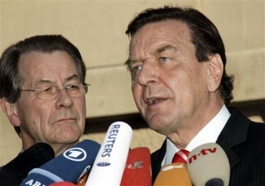 German Chancellor Gerhard Schroeder, right, and Social Democratic Party Chairman Franz Muentefering, left, deliver statements after their talks with Christian Democratic Party Chairwoman Angela Merkel in Berlin Thursday, Sept. 22, 2005.