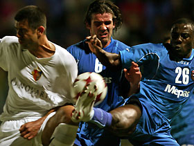 William Etshu Tabi (R) and Ivica Landeka (C) of NK Siroki Brijeg fight for the ball with FC Basel's Boris Smiljanic during their UEFA Cup first round, second leg soccer match in Siroki Brijeg September 29, 2005.