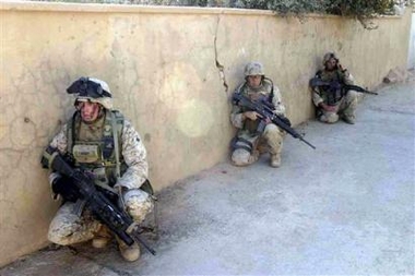 Marines from 3rd Platoon, Company K, 3rd Battalion, 1st Marine Regiment, and soldiers of the Iraqi Security Forces survey an area while patrol the streets of Haditha, Iraq while in search of insurgents on Tuesday Oct. 4 2005.