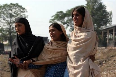 Kashmiri survivors weep as they arrive to see family members near the Nisar military camp in northern Pakistani town of Muzaffarabad, Tuesday Oct. 11, 2005.