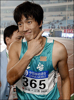 Olympic gold medallist Liu Xiang of China reacts after winning the final of the 110-meter hurdles at the 10th National Games of the People's Republic of China in Nanjing