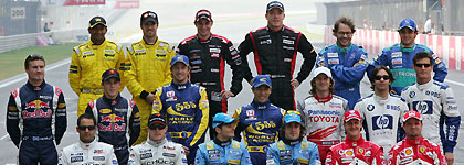 Formula One drivers pose for a team photo before the start of the Chinese Grand Prix in Shanghai October 16, 2005. Front row (L-R) Juan Pablo Montoya, Kimi Raikkonen, Giancarlo Fisichella, Fernando Alonso, Michael Schumacher and Rubens Barrichello. Middle row (L-R) David Coulthard, Christian Klein, Jenson Button, Takuma Sato, Jarno Trulli, Antonio Pizzonia and Mark Webber. Back row (L-R) Narain Karthikeyan, Tiago Monteiro, Christijan Albers, Robert Doornbos, Jacques Villeneuve and Felipe Massa. Missing are Ralf Schumacher and Nick Heidfeld.