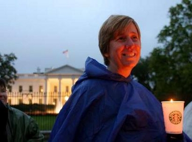 Cindy Sheehan, the military mother who made her son's death in Iraq a rallying point for the anti-war movement, holds a candle in front of the White House in Washington, D.C., October 25, 2005.