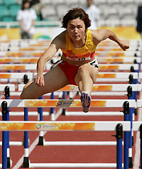 Feng Yun competes in the women's 100 metre hurdles final at the 4th East Asian Games in Macau November 4, 2005. Feng won the gold medal in the event.