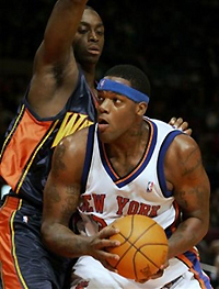 New York Knicks' Eddy Curry, right, drives to the basket past Golden State Warriors' Chris Taft in the first half in New York on Sunday, Nov. 6, 2005. 