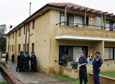 Police stand outside a western Sydney apartment block that was raided by police in the early hours of Tuesday, Nov. 8, 2005.