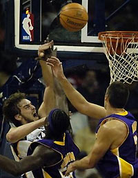 Memphis Grizzlies' Pau Gasol of Spain, left, is fouled by Los Angeles Lakers' Kwame Brown, middle, as Chris Mihm, right, looks on during the third quarter on Monday, Nov. 14, 2005, in Memphis