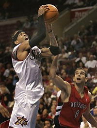 Philadelphia 76ers Allen Iverson is fouled by Toronto Raptors Jose Calderon as he goes up for a shot in the fourth quarter Tuesday, Nov. 15, 2005 in Philadelphia.