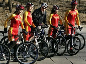 Bush rides his mountain bike on the Laoshan Olympic mountain bike course in Beijing, November 20, 2005. Bush took time out of his busy two-day Beijing schedule to exercise on his bike with Chinese cyclists